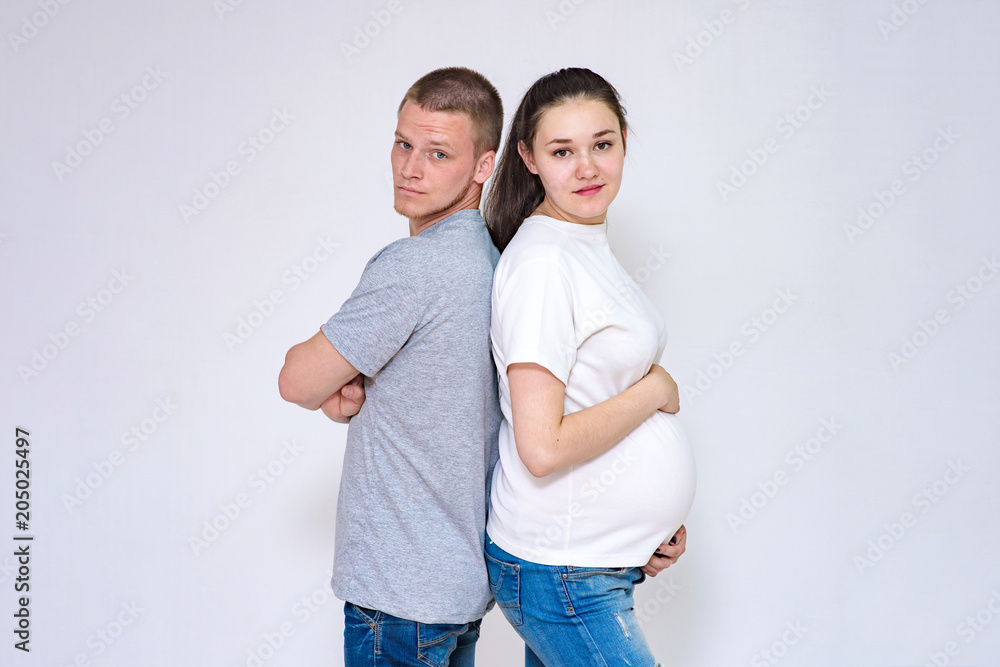 husband and pregnant wife communicate in studio on white background husband and pregnant wife communicate in studio on white background