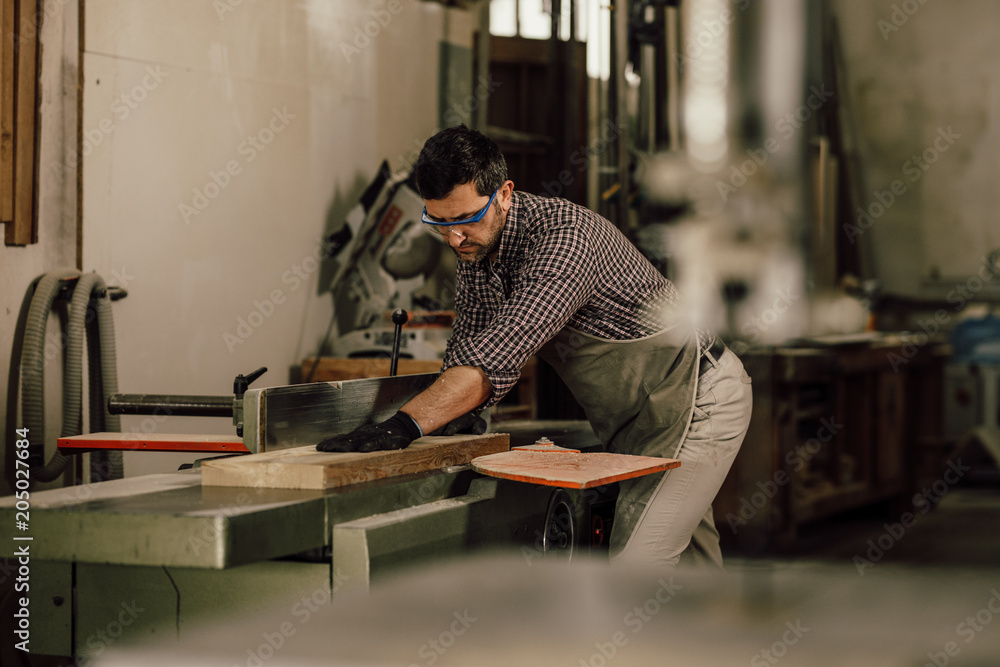 Professional carpenter at work in his laboratory Professional carpenter at work in his laboratory
