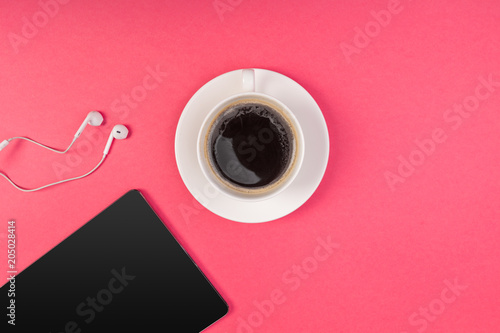 Digital tablet with blank screen and cup of coffee