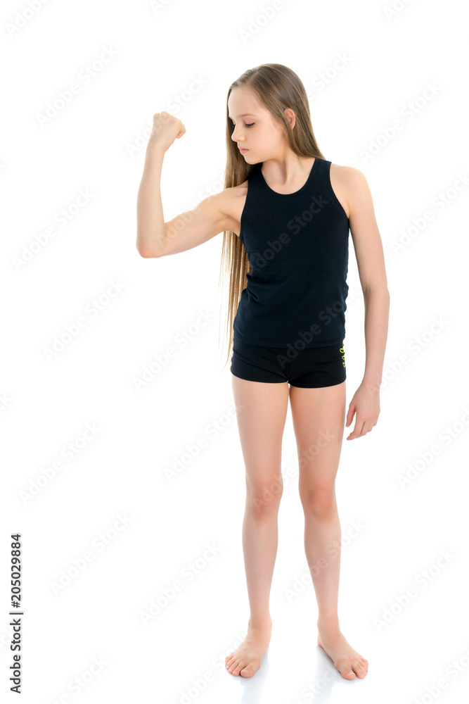 A little girl shows her muscles. A little girl shows her muscles.