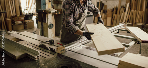 Skilled Carpenter craftsman at work in his workshop photo