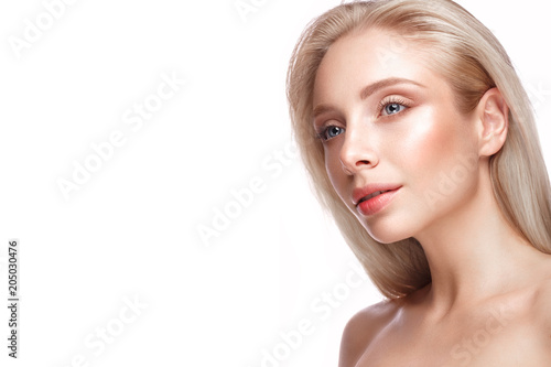 Beautiful young girl with a light natural make-up and perfect skin. Beauty face. Picture taken in the studio on a white background.