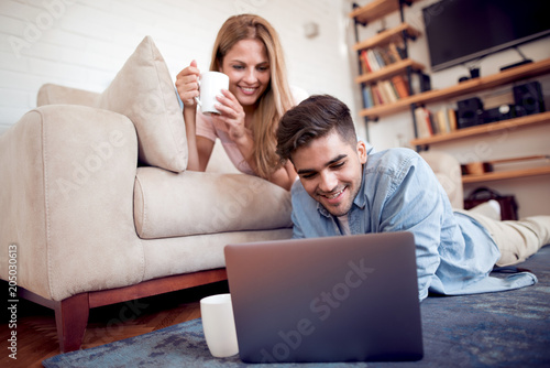 Beautiful couple using laptop