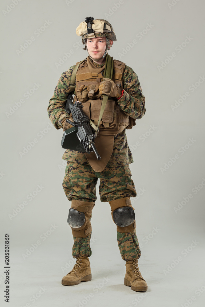 Soldier in camouflage holding rifle Soldier in camouflage holding rifle