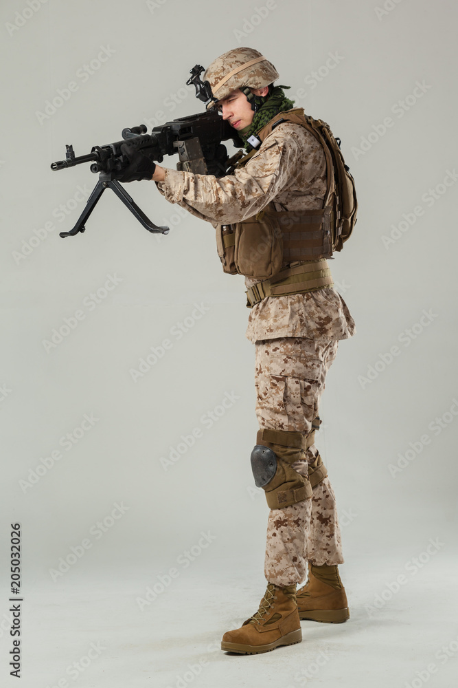 Soldier in camouflage holding rifle Soldier in camouflage holding rifle