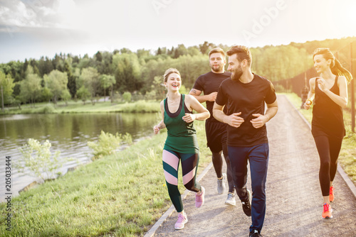 Fototapeta Naklejka Na Ścianę i Meble -  Friends jogging outdoors