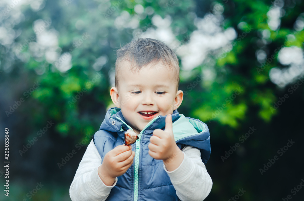 baby, little boy eating a piece of shish kebab meat, outdoors baby, little boy eating a piece of shish kebab meat, outdoors
