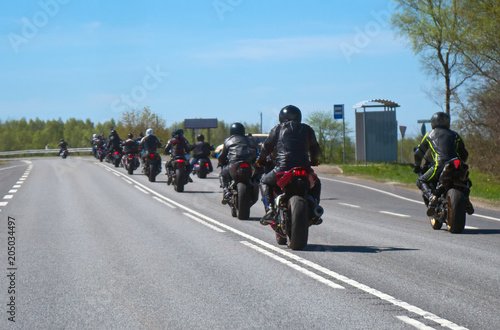 Column of bikers riding on the road. © M-Production