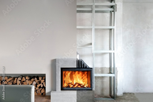 Installation of wood stove insert in livingroom photo