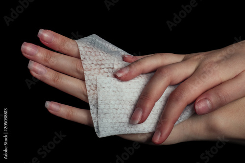 Hands of a woman cleaning with a baby wipe isolated on a white background
