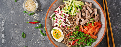 Buckwheat noodles  with beef, eggs and vegetables. Korean food.  Buckwheat pasta soup. Top view. Flat lay. Banner