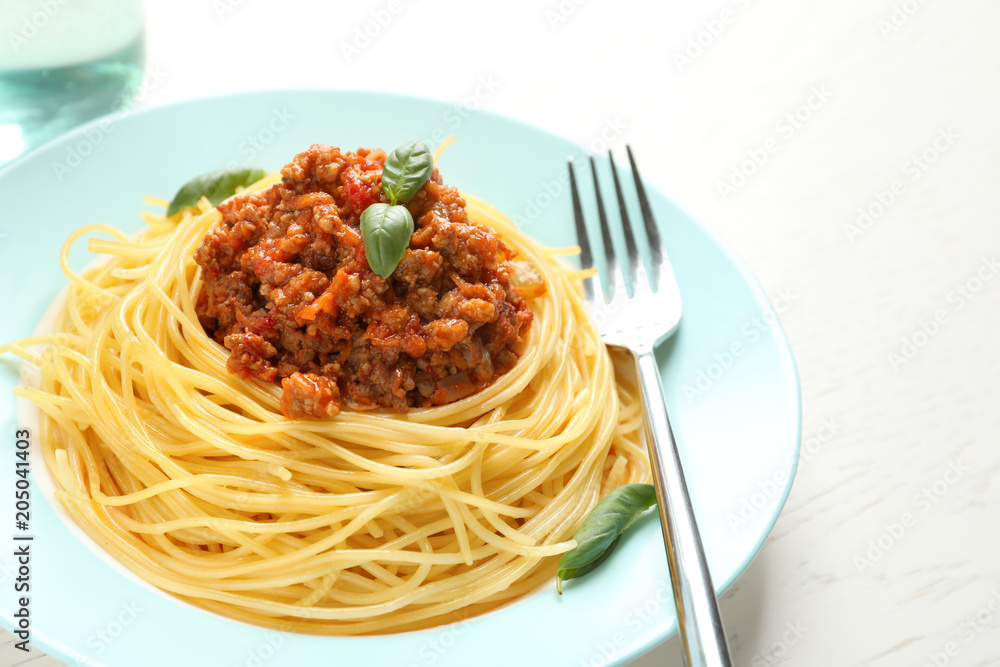 Plate with delicious pasta bolognese on table
