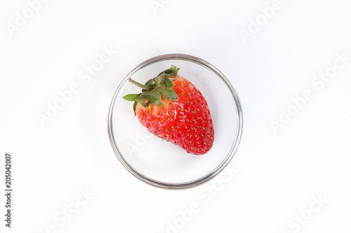 One Red Ripe Strawberry in small glass bowl