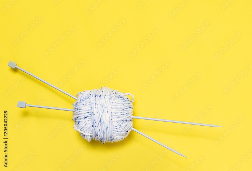 Top view of yarn on yellow background Top view of yarn on yellow background