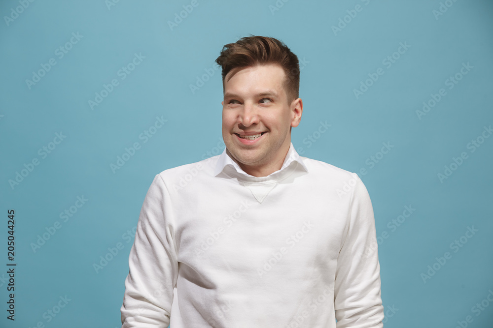 The happy business man standing and smiling against studio background. The happy business man standing and smiling against studio background.