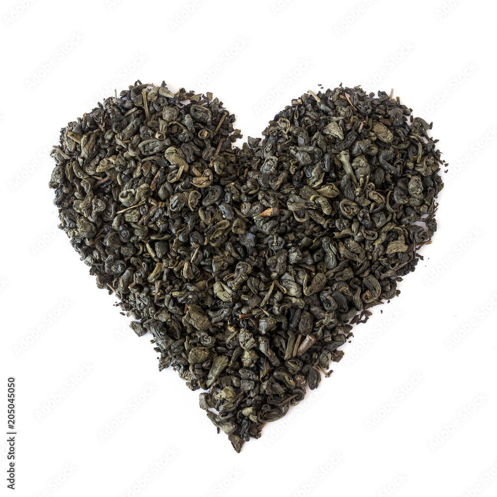 Organic dried green tea leaves placed in a heart shape. Organic dried green tea leaves placed in a heart shape.