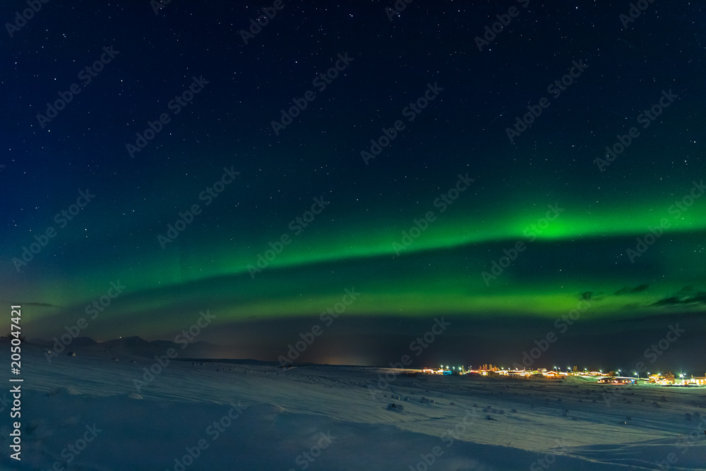 Northern lights over town of Hauganes in Iceland