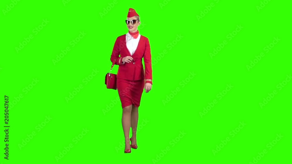 Girl steps and waves, she is the stewardess. Green screen. Slow motion Girl steps and waves, she is the stewardess. Green screen. Slow motion