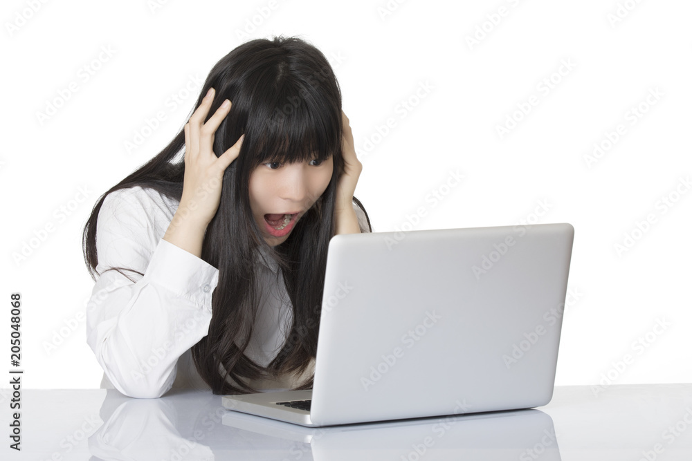 Asian woman sitting at desk stressed isolated on white background Asian woman sitting at desk stressed isolated on white background
