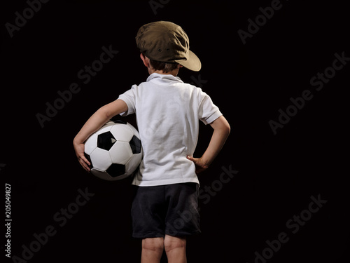 Young child holding a soccer ball