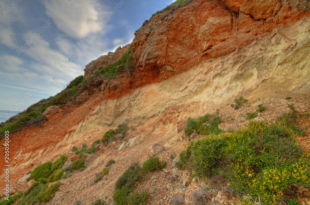 Soil profile in a cliff, showing terra rossa, reddish soil, heavy and clay-rich, developed on a limestone base