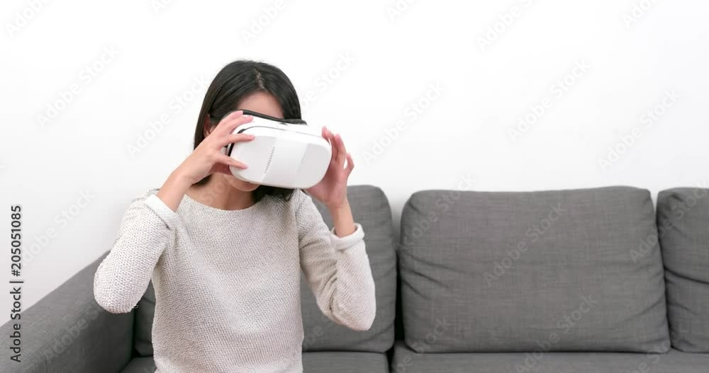 Woman watching with VR device at home Woman watching with VR device at home