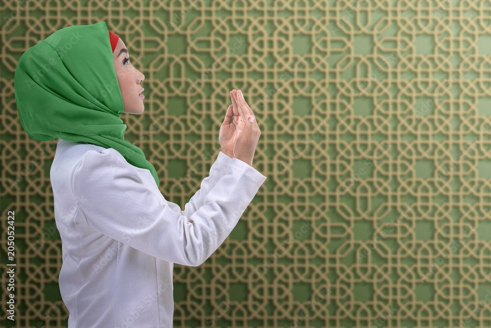 Side view of asian muslim woman praying to god Side view of asian muslim woman praying to god