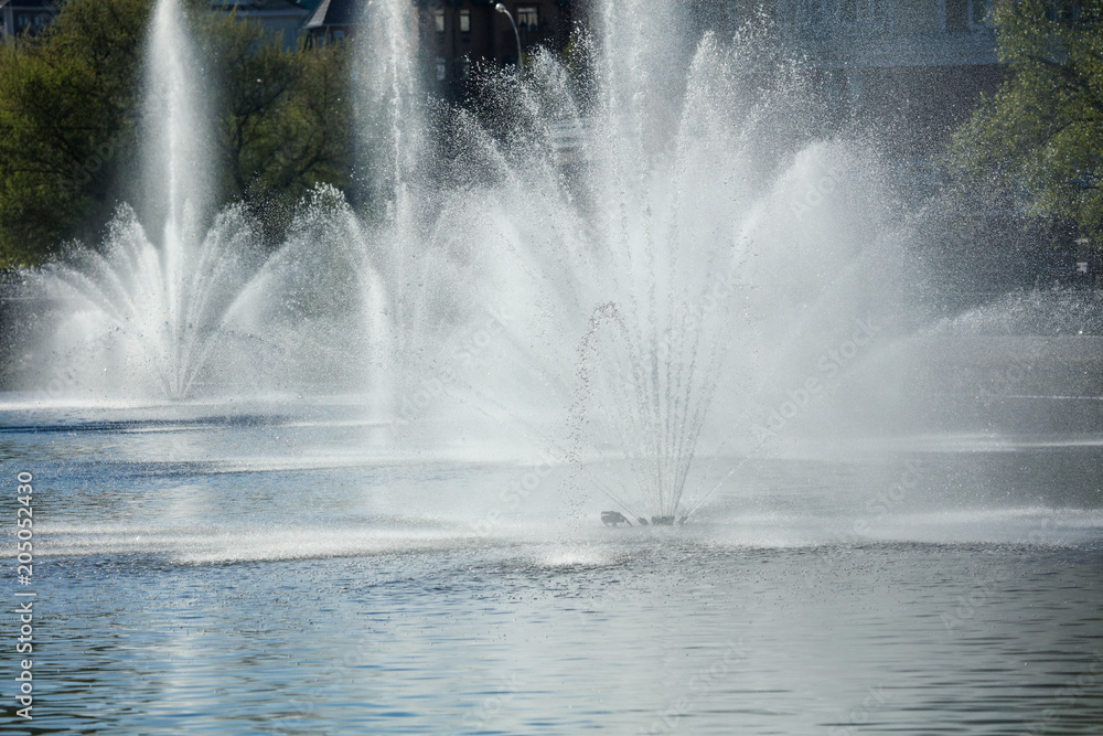 Spray from the fountain in the city as a background Spray from the fountain in the city as a background