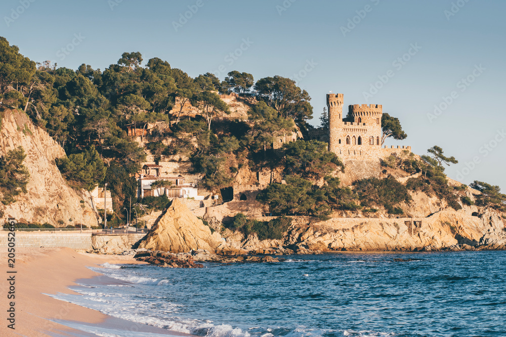 Landscape of Lloret de Mar Castle and its beach in a sunny afternoon, Spain.