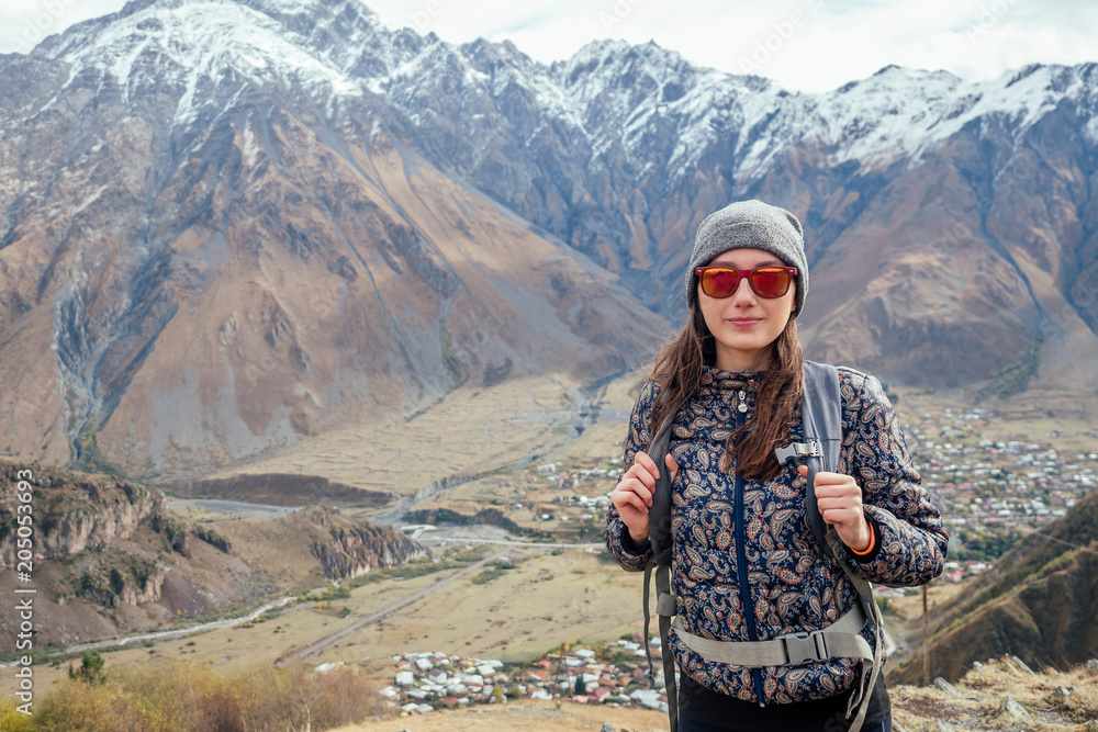 joyful girl in sunglasses in the mountains