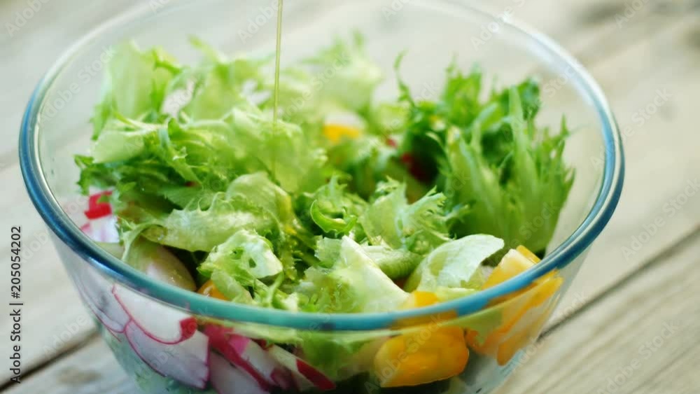 Closeup - pouring dressing over salad. Seamless cinemagraph looped video Closeup - pouring dressing over salad. Seamless cinemagraph looped video