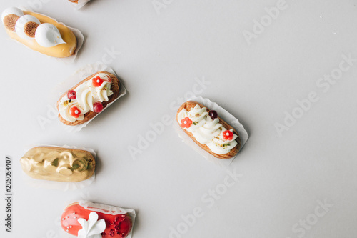 Assorted delicious sweets on grey background