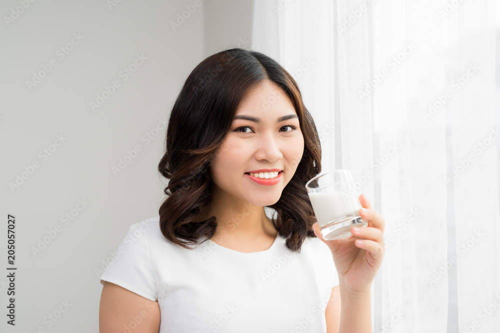 Happy young woman drinking milk Happy young woman drinking milk