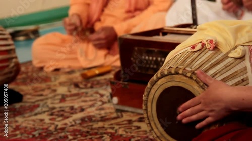 Krishna plays on Indian musical spiritual instruments