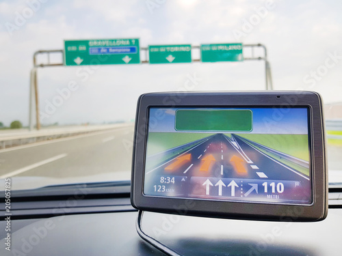 Travel concept with GPS, navigation inside a car on road in natural background, (Global Positioning System)