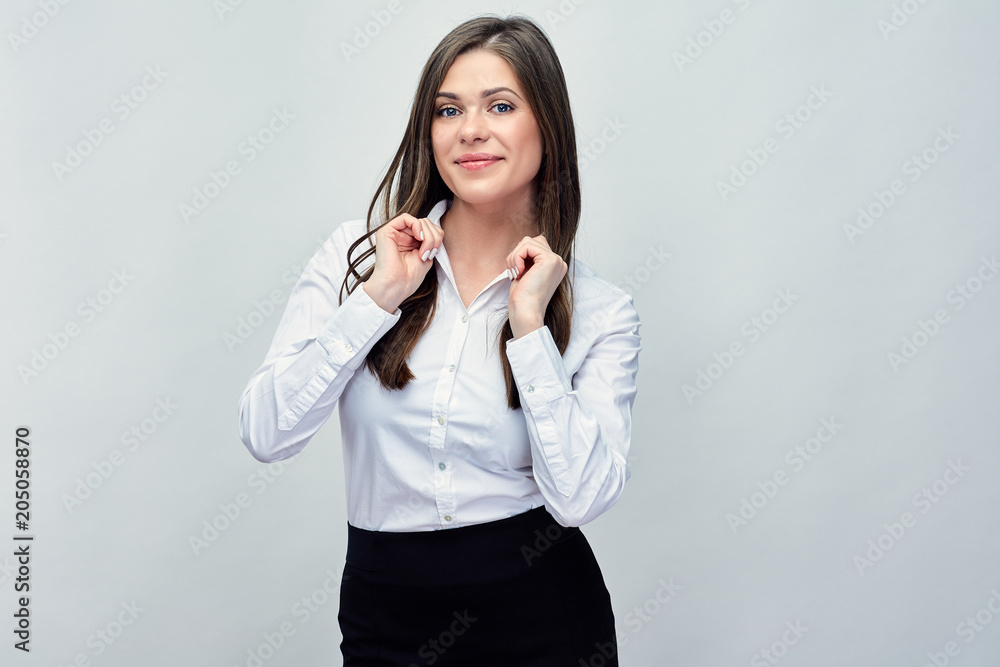 Businesswoman wearing white shirt standing in front of studio ba Businesswoman wearing white shirt standing in front of studio ba