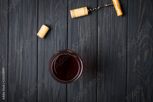 Glass of red wine on gray wooden table. View from top