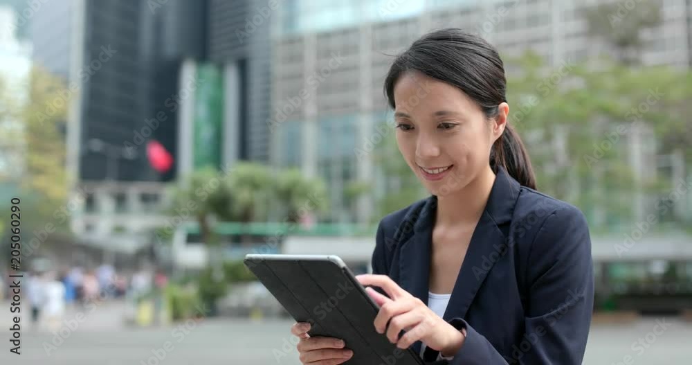 Business woman use of tablet computer at outdoor city Business woman use of tablet computer at outdoor city