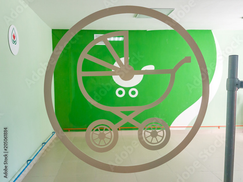 green baby carriage sign painted on scratched wooden board texture background photo