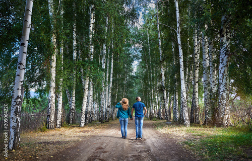 Hipster couple in the birch wood