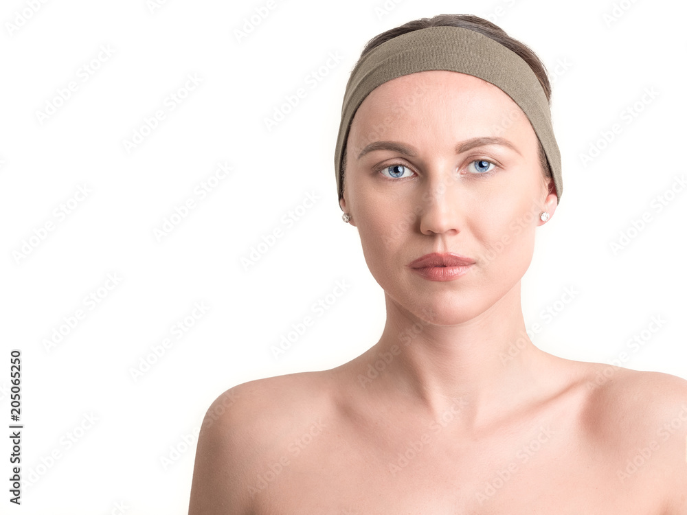 Beautiful young woman's face with clean skin - isolated on white. Beautiful young woman's face with clean skin - isolated on white.