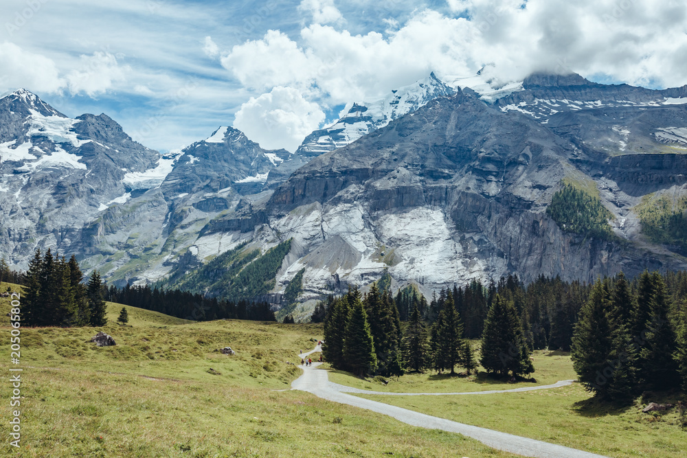 The road to the picturesque glacial lakes Oeschinensee. Location Swiss alps, Kandersteg, Europe.