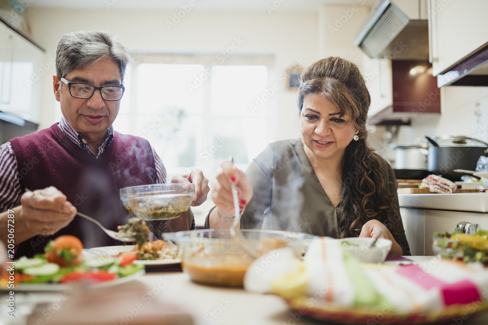 Mature Couple Enjoying Dinner at Home Mature Couple Enjoying Dinner at Home