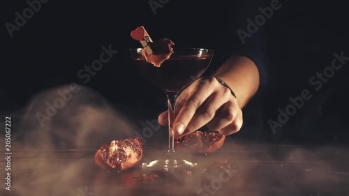 Barman serves a cocktail at the bar