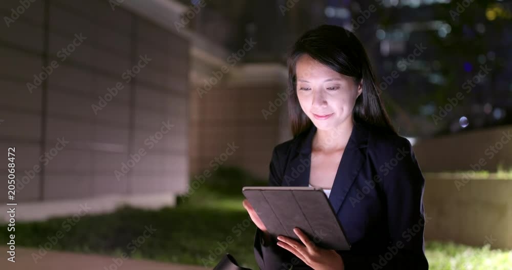 Business woman look at tablet computer at night Business woman look at tablet computer at night