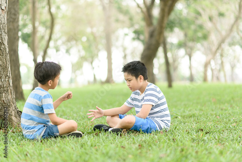 Two boy sit and play together