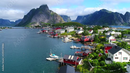 Aerial footage of small fishing village of Hamnoy on Lofoten islands in Norway, popular tourist destination with its typical red houses and natural beauty. Aerial 4k Ultra HD.
