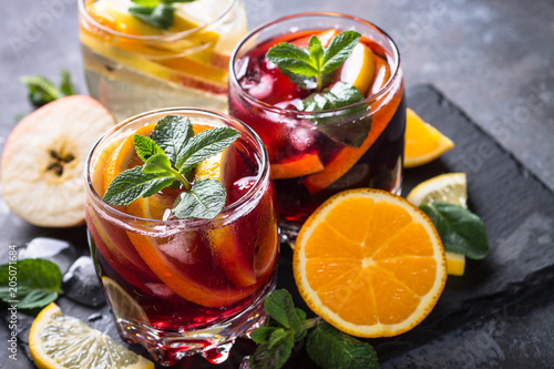 Sangria with fruit, ice and mint in glass. 
