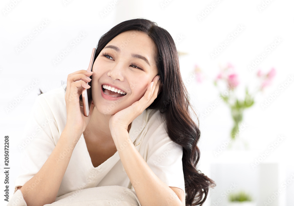 happy woman sitting on couch and talking on the phone happy woman sitting on couch and talking on the phone