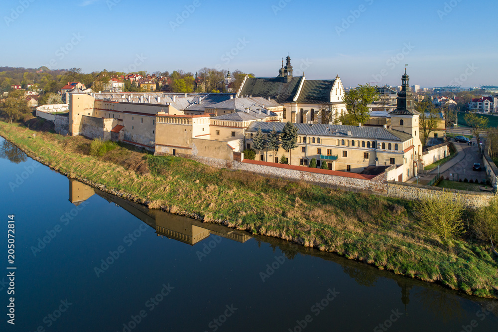 Fototapeta premium Krakow, Poland. Norbertine fenake nunnery, church, and reflection in Vistula river. Aerial view in sunrise light
